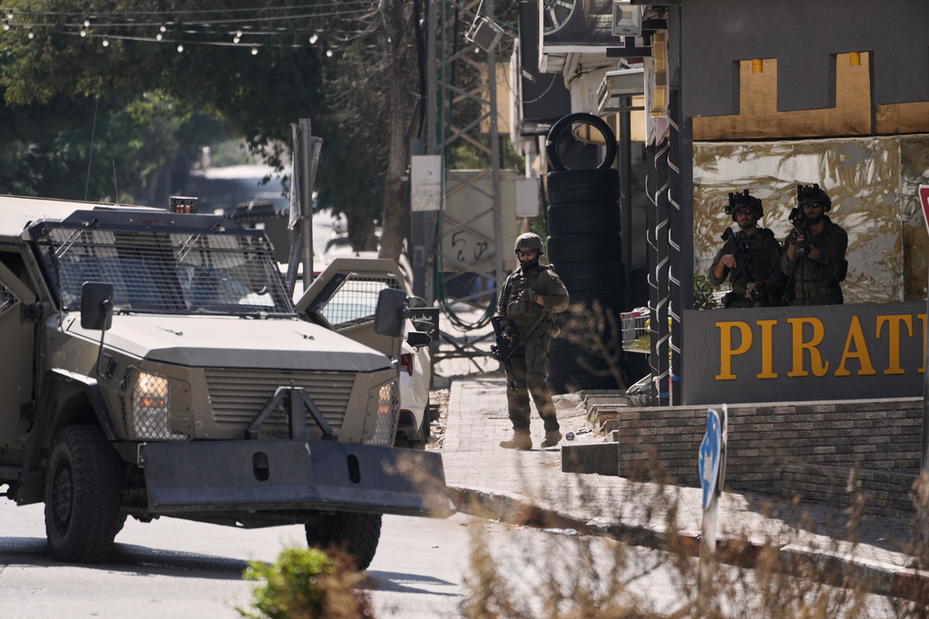 Israeli soldiers stand in guard on a street outside the Nablus Speciality Hospital in the West Bank city of Nablus, Friday, July 24, 2026, after Israeli military killed, according to health authorities, at least four Palestinians in the village of Tell in the northern West Bank. (AP Photo/Majdi Mohammed)