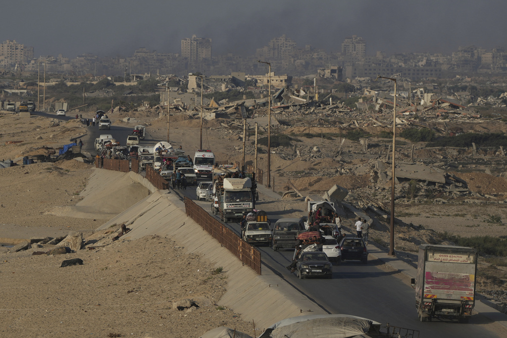 Displaced Palestinians fleeing northern Gaza Strip move with their belongings along the Sea Road, near Wadi Gaza, Saturday, Aug. 30, 2025. (AP Photo/Abdel Kareem Hana)