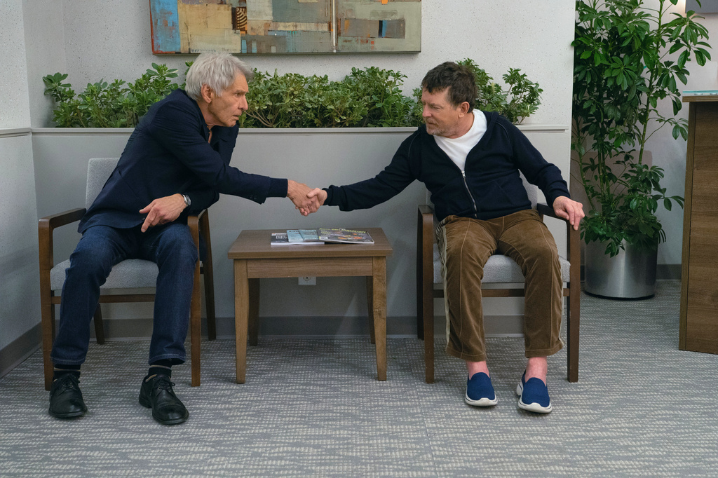 This image released by Apple TV+ shows Harrison Ford, left, and Michael J. Fox in a scene from "Shrinking." (Apple TV+ via AP)