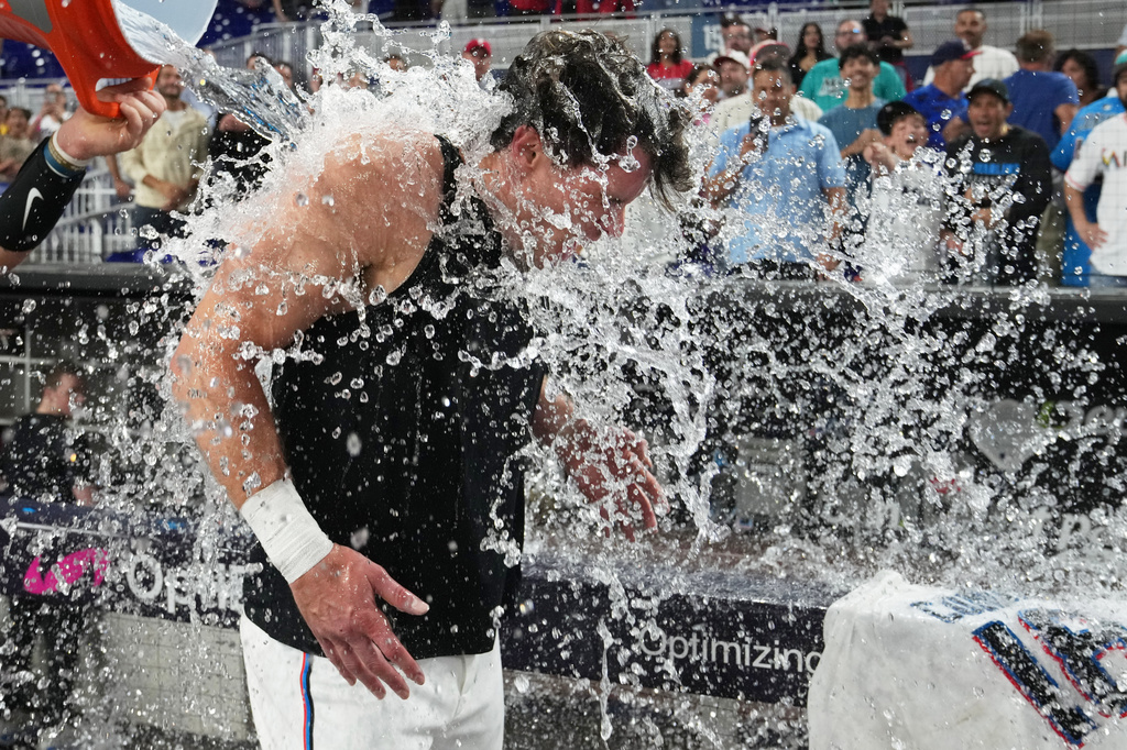 Miami Marlins' Griffin Conine, right, is doused after hitting a walk off single to defeat the Philadelphia Phillies in the the ninth inning of a baseball game, Monday, July 27, 2026, in Miami. (AP Photo/Lynne Sladky)