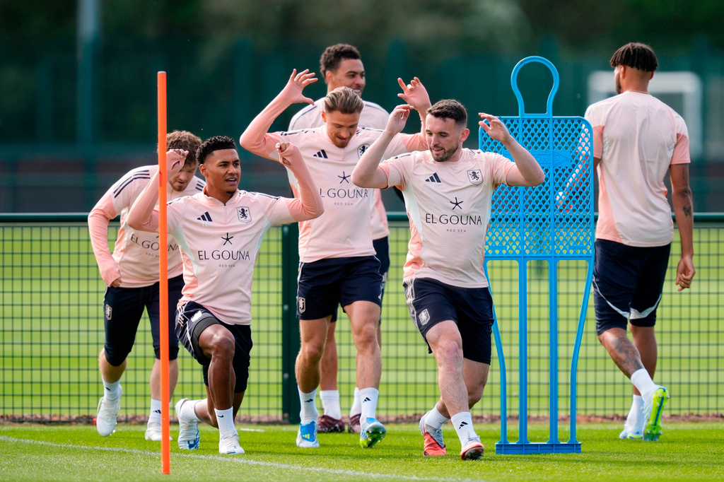 Aston Villa's Ollie Watkins, second left, and John McGinn, second right, attend a training session in Birmingham, England, Wednesday April 29, 2026. (Nick Potts/PA via AP)
