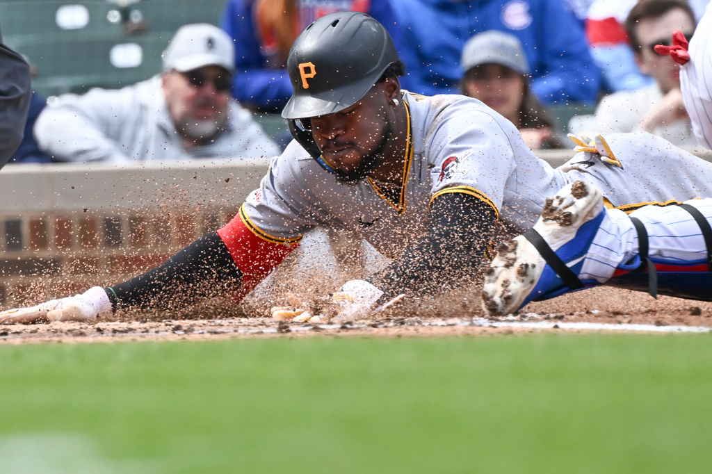 Pittsburgh Pirates' Oneil Cruz (15) scores against the Chicago Cubs during the third inning of a baseball game, Saturday, April 11, 2026, in Chicago. (AP Photo/Matt Marton)