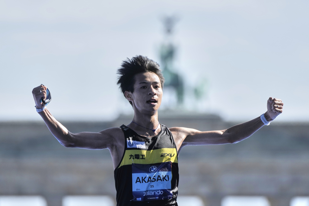 Japan's Akira Akasaki crosses the finish line to finish second in the Berlin Marathon in Berlin, Germany, Sunday, Sept.21, 2025. (AP Photo/Markus Schreiber)