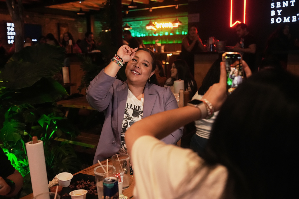 Fans gather to celebrate the release of Taylor Swift's new album, "The Life of a Showgirl" in Mexico City, Thursday, Oct. 2, 2025. (AP Photo/Claudia Rosel)