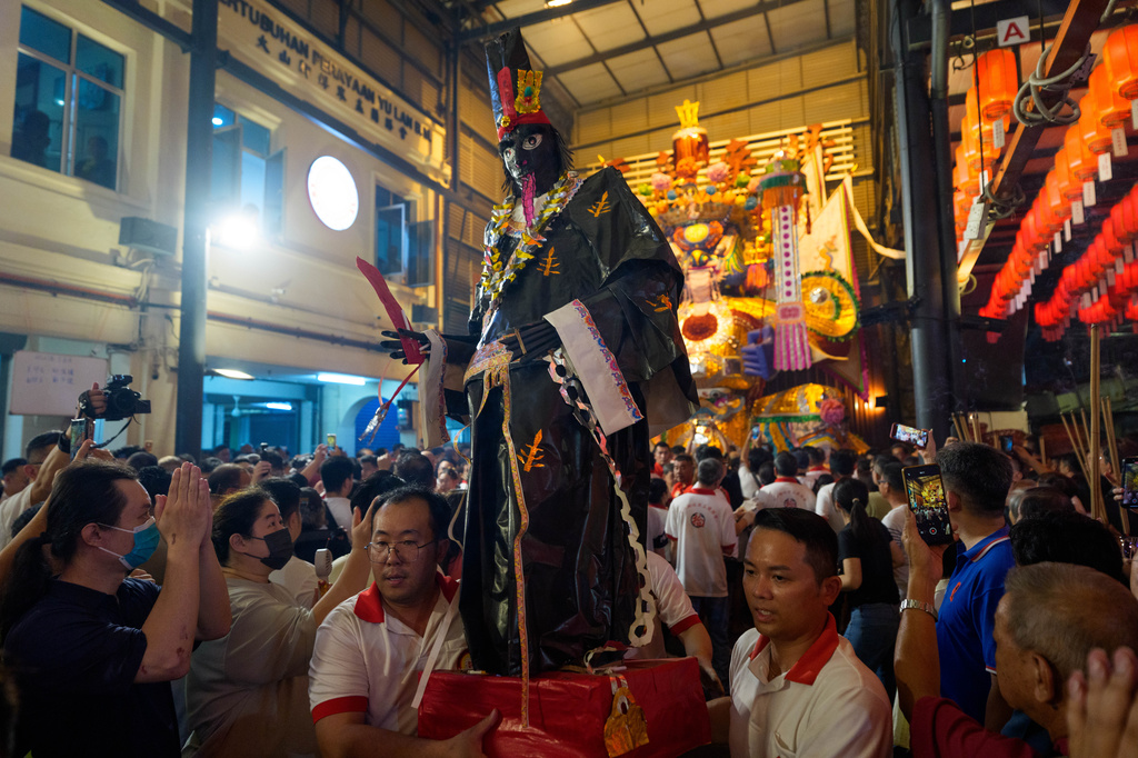 Participants carry a figure representing a Chinese deity during the Hungry Ghost Festival in Bukit Metajam, Malaysia, Saturday, Aug. 29, 2026. (AP Photo/Vincent Thian)