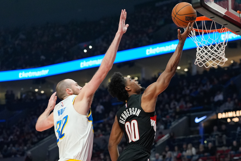 Portland Trail Blazers guard Scoot Henderson (00) shoots as Indiana Pacers center Jay Huff (32) defends during the first half of an NBA basketball game Sunday, March 8, 2026, in Portland, Ore. (AP Photo/Jenny Kane)