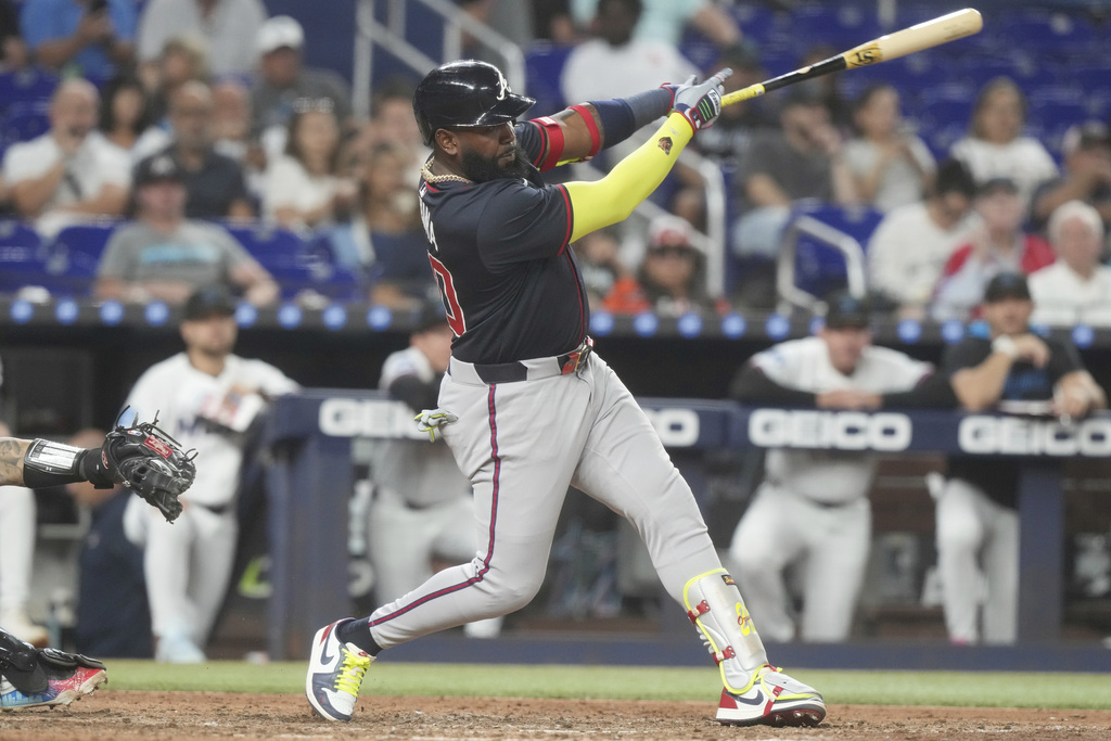 Atlanta Braves' Marcell Ozuna hits a double to left field during the ninth inning of a baseball game against the Miami Marlins, Tuesday, Aug. 26, 2025, in Miami. (AP Photo/Marta Lavandier)
