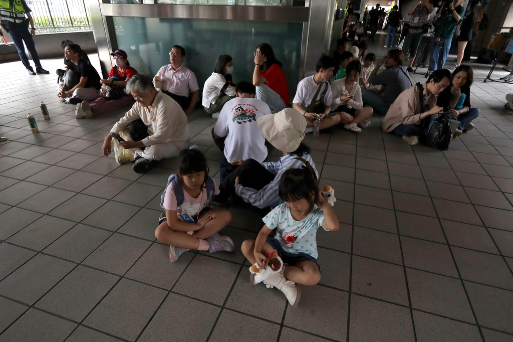 People take cover inside at a MRT station during the Urban Resilience (Air-Defense) Exercise, part of the annual Han Kuang military exercises in Taipei, Taiwan, Thursday, Aug. 13, 2026. (AP Photo/Chiang Ying-ying)