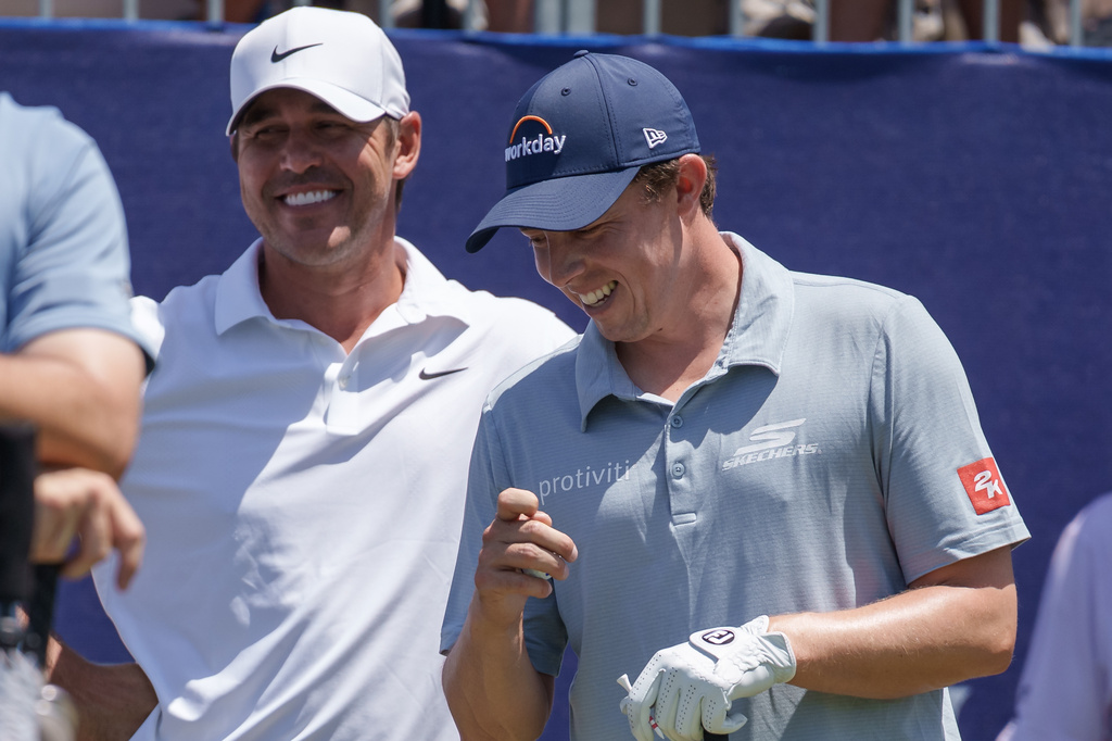 Brooks Koepka and Matt Fitzpatrick, of England, talk before teeing off on the first hole during the first round of the PGA Zurich Classic golf tournament, Thursday, April 23, 2026, in Avondale, La. (AP Photo/Matthew Hinton)