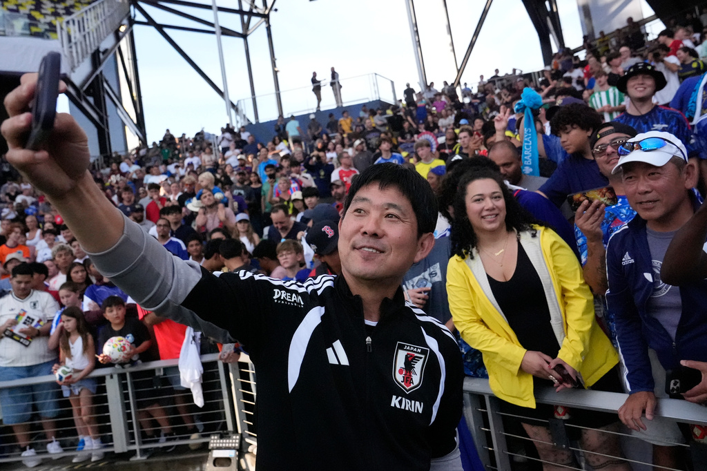 Japan head coach Hajime Moriyasu takes a picture with fans after a training session Monday, June 8, 2026, in Nashville, Tenn., ahead of the World Cup soccer tournament. (AP Photo/George Walker IV)