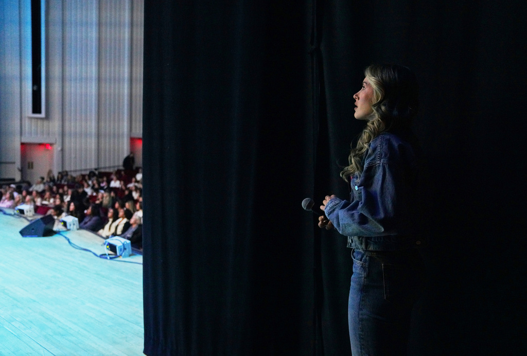 Angela Halili, 29, cohost of the Christian podcast, "Girls Gone Bible," stands backstage before their live show as fans and followers sing worship music in the Atlanta Symphony Hall, Friday, Nov. 14, 2025, in Atlanta. (AP Photo/Jessie Wardarski)