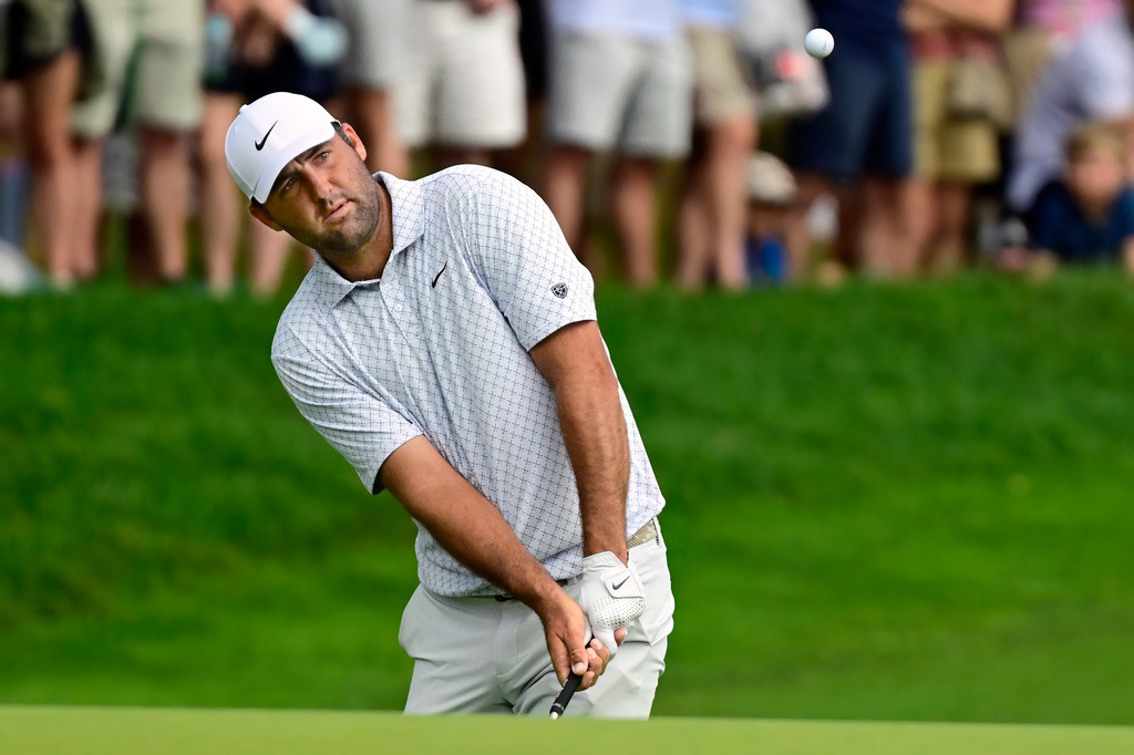 Scottie Scheffler hits at the 15th hole during the third round of the Travelers Championship golf tournament at TPC River Highlands, Saturday, June 27, 2026, in Cromwell, Conn. (AP Photo/Jessica Hill)