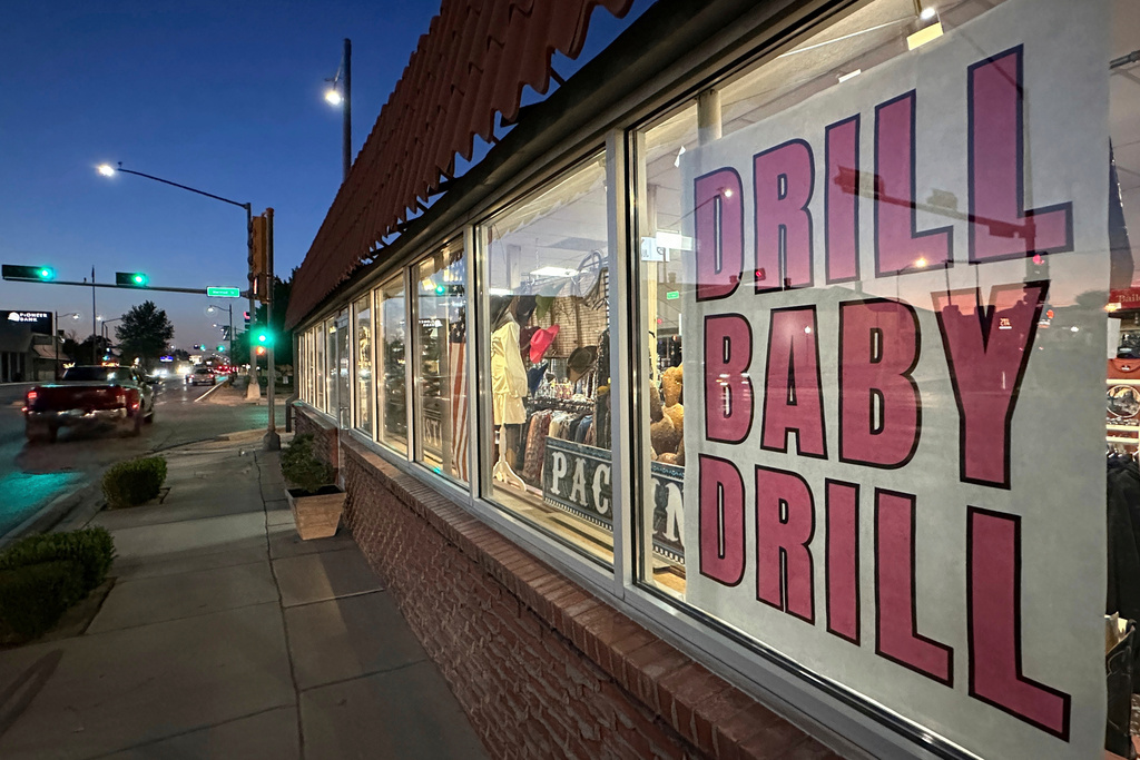 FILE - A sign in support of the oil and natural gas industry is displayed in a shop window along a main street in Carlsbad, N.M., May 20, 2025. (AP Photo/Susan Montoya Bryan, File)