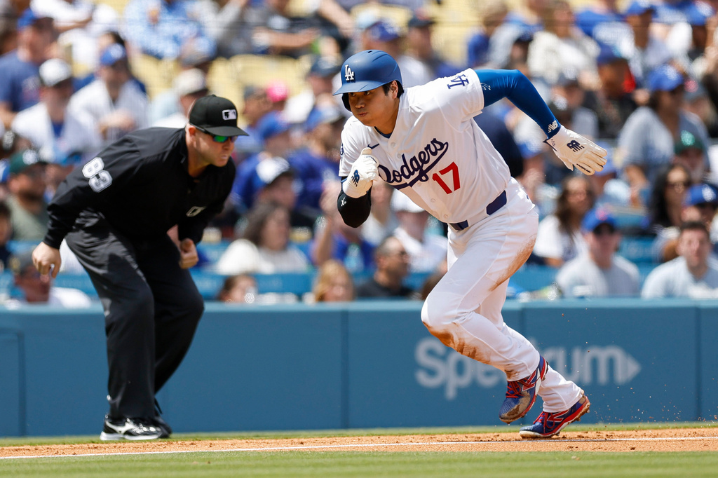 Los Angeles Dodgers designated hitter Shohei Ohtani (17) runs to home plate to score off a sacrifice fly hit by Dodgers' Andy Pages during the first inning of a baseball game against the Chicago Cubs, Sunday, April 26, 2026, in Los Angeles. (AP Photo/Caroline Brehman)