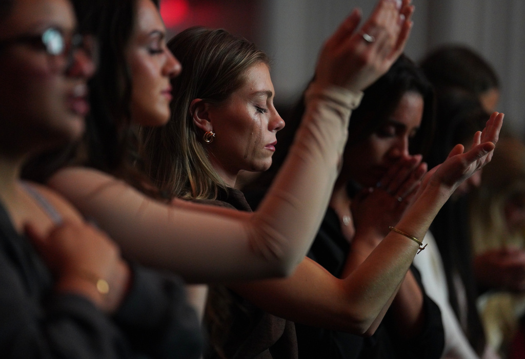 Followers of the Christian podcast, "Girls Gone Bible," cry during the live show held at the Atlanta Symphony Hall, Friday, Nov. 14, 2025, in Atlanta. (AP Photo/Jessie Wardarski)