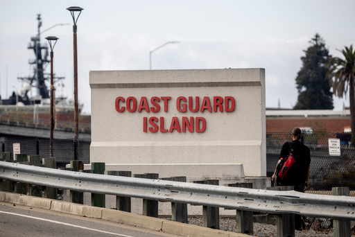 A sign stands by the bridge that leads to Coast Guard Island Alameda in Oakland, Calif., Wednesday, Oct. 22, 2025. (Stephen Lam/San Francisco Chronicle via AP) A sign stands by the bridge that leads to Coast Guard Island Alameda in Oakland, Calif., Wednesday, Oct. 22, 2025. (Stephen Lam/San Francisco Chronicle via AP)