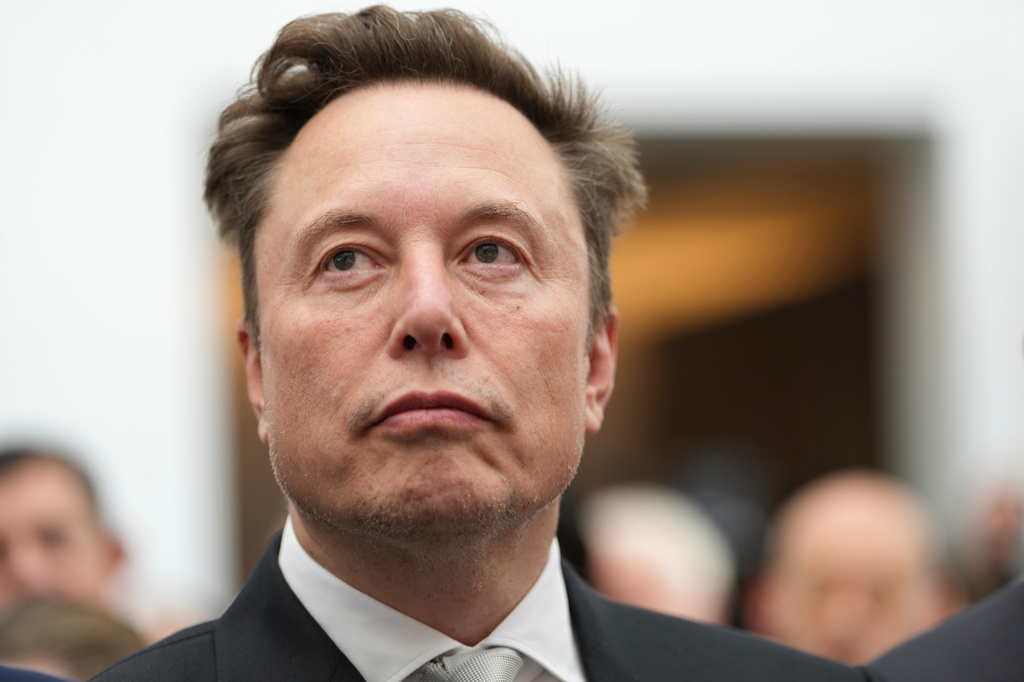 FILE - Elon Musk listens as President Donald Trump speaks during an event at the U.S. Institute of Peace, Oct. 8, 2026, in Washington. (AP Photo/Julia Demaree Nikhinson, File)