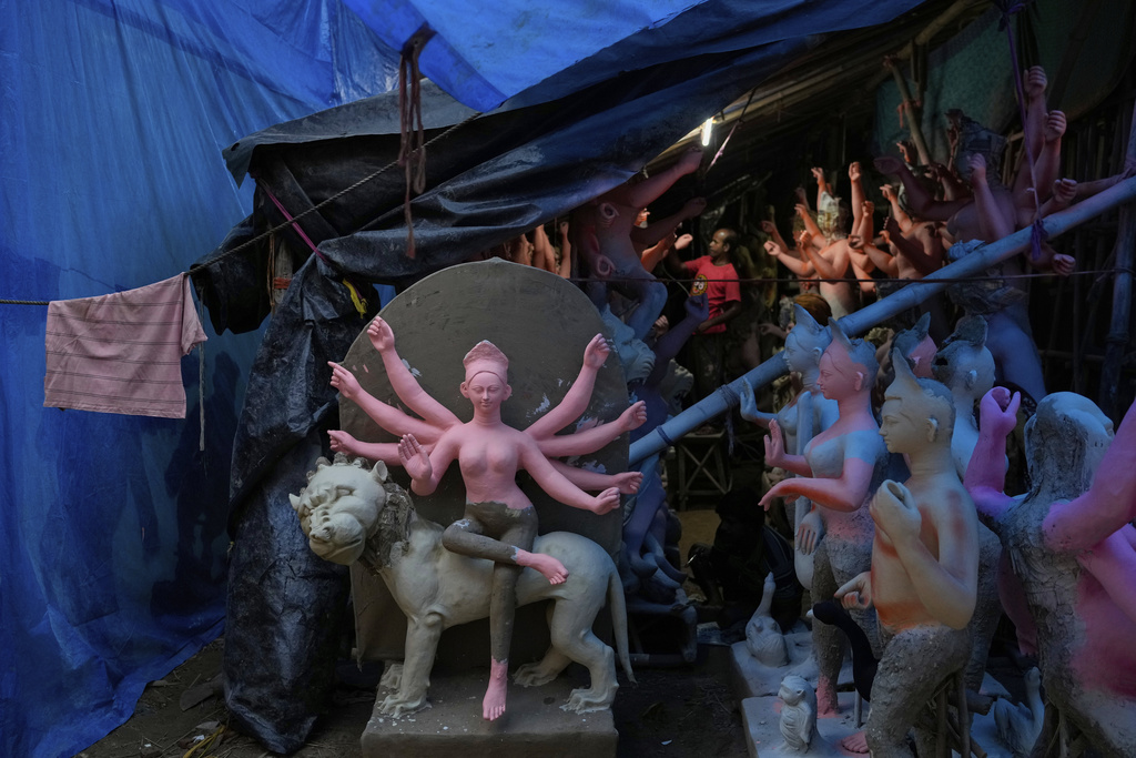 An artist from Kolkata prepares idols of Hindu goddess Durga ahead of the Durga Puja festival, in New Delhi, India, Friday, Sept. 19, 2025. (AP Photo/Manish Swarup)