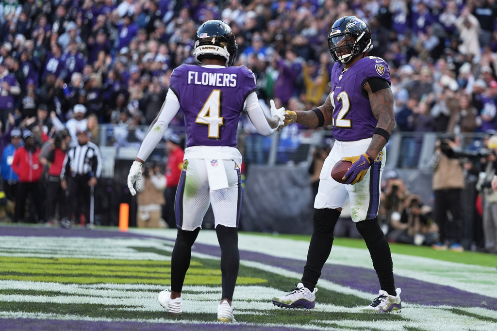 Baltimore Ravens running back Derrick Henry (22) shakes hands with wide receiver Zay Flowers (4) after scoring a touchdown during the second half of an NFL football game against the New York Jets, Sunday, Nov. 23, 2025, in Baltimore. (AP Photo/Stephanie Scarbrough)