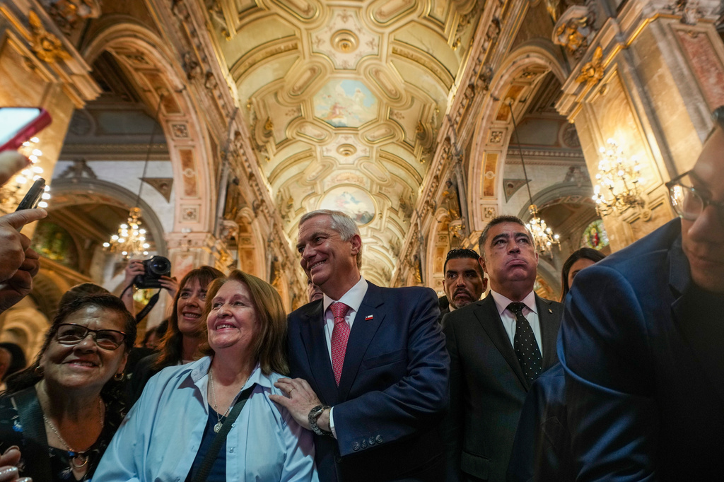 FILE - Chilean President-elect Jose Antonio Kast and his wife Maria Pia Adriasola greet supporters at the Santiago Cathedral after attending Mass in Santiago, Chile, Friday, Dec. 19, 2025. (AP Photo/Esteban Felix, File)