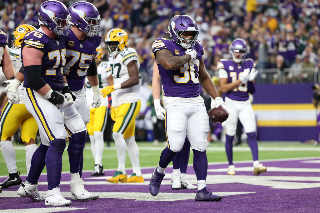 Minnesota Vikings fullback C.J. Ham (30) celebrates after a 1-yard touchdown run during the first half of an NFL football game against the Green Bay Packers, Sunday, Jan. 4, 2026, in Minneapolis. (AP Photo/Ellen Schmidt)