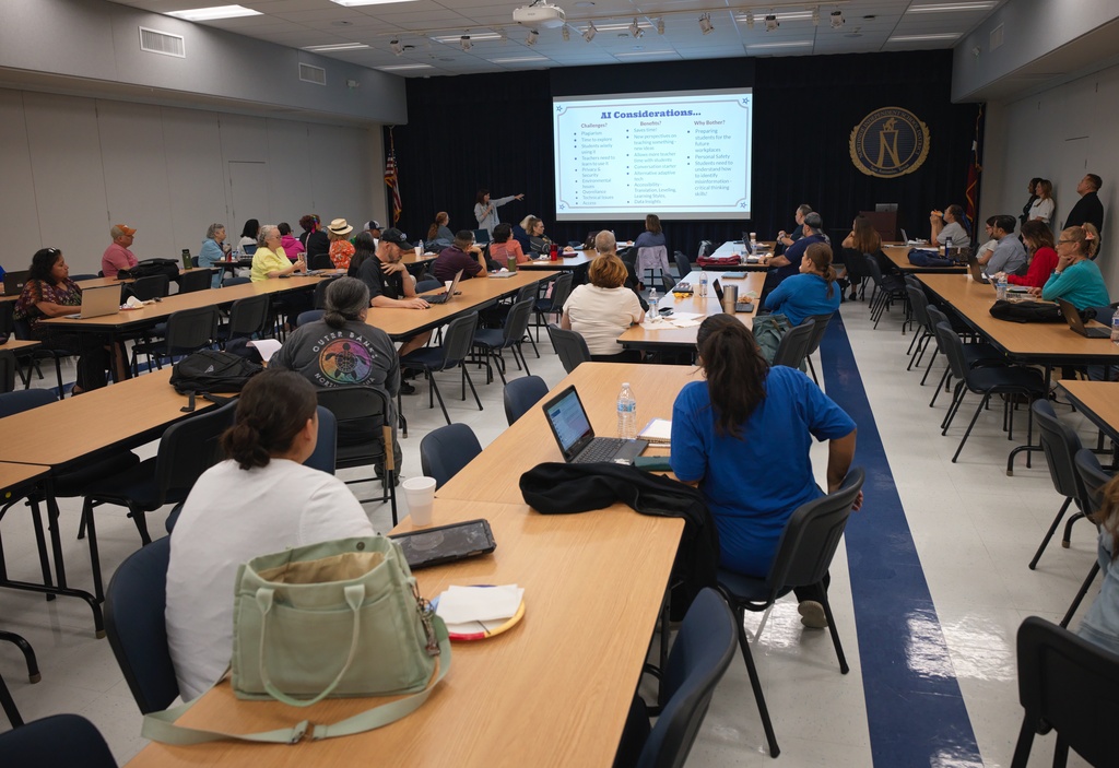 Kathleen Torregrossa, Ed.D, rear, lectures during a Microsoft AI skilling event, Saturday, Sept. 27, 2025, in San Antonio. (AP Photo/Darren Abate)