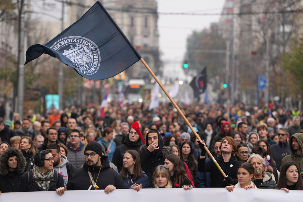 Led by university students, people attend a protest in front of a military complex that was partially destroyed in a NATO bombing campaign in 1999, after Serbian lawmakers on Friday passed a special law clearing the way for a controversial real estate project that would be financed by an investment company linked to President Trump's son-in-law Jared Kushner, in Belgrade, Serbia, Tuesday, Nov. 11, 2025. (AP Photo/Darko Vojinovic)