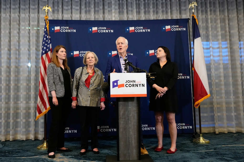 Sen. John Cornyn, R-Texas, center right, speaks alongside, from left, daughter Danley Cornyn, wife Sandy Cornyn and daughter Haley Cornyn, during a primary runoff election night event after losing the Republican party's nomination Tuesday, May 26, 2026, in Austin. (AP Photo/Ashley Landis)