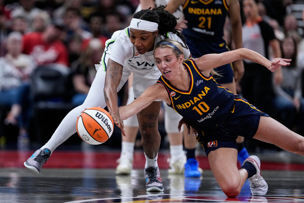 Indiana Fever guard Lexie Hull (10) and Minnesota Lynx forward Liatu King go for a loose ball in the first half of a WNBA basketball game in Indianapolis, Tuesday, Sept. 22, 2026. (AP Photo/Michael Conroy)