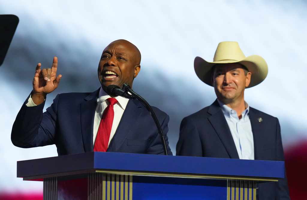 Sen. Tim Scott, R-S.C., left, and Montana Attorney General Austin Knudsen arrive to speak at the Republican convention Wednesday, Sept. 9, 2026, in Dallas. (AP Photo/Julio Cortez)