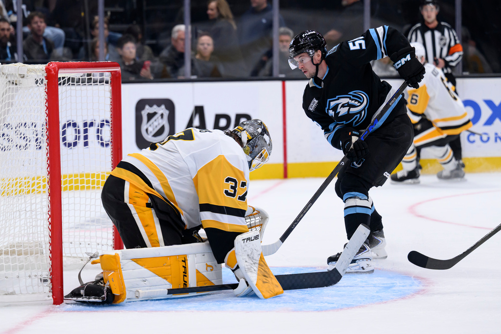 Utah Mammoth right wing Kailer Yamamoto, front right, scores against Pittsburgh Penguins goaltender Arturs Silovs (37) during the second period of an NHL hockey game Monday, Oct. 19, 2026, in Salt Lake City. (AP Photo/Tyler Tate)