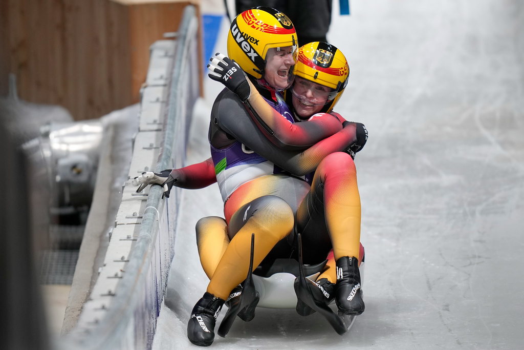 Germany's silver medalists Dajana Eitberger, left, and Magdalena Matschina, right, celebrate as they arrive at the finish during a women's doubles luge run at the 2026 Winter Olympics, in Cortina d'Ampezzo, Italy, Wednesday, Feb. 11, 2026. (AP Photo/Aijaz Rahi)