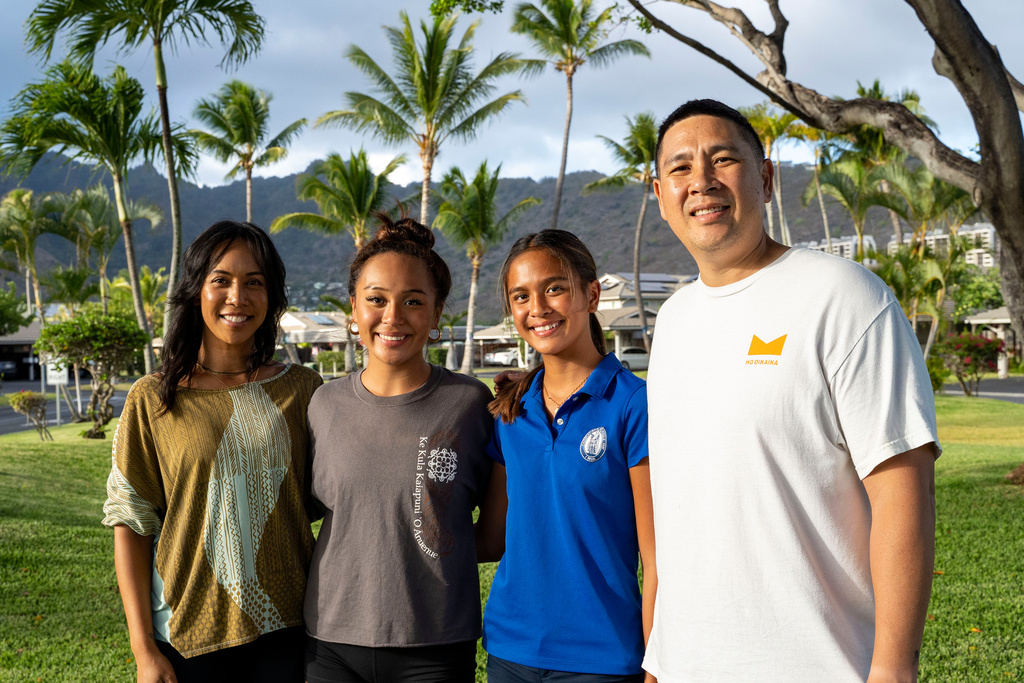 Kapua Ong, second from right, poses for a family portrait with her parents and sister in Honolulu, on Thursday, Sept. 11, 2025. (AP Photo/Mengshin Lin)
