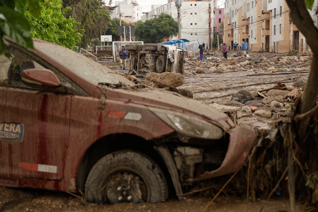 People work on a destroyed road after heavy raid triggered flooding in Arequipa, Peru, Monday, Feb. 23, 2026. (AP Photo/Jose Sotomayor)