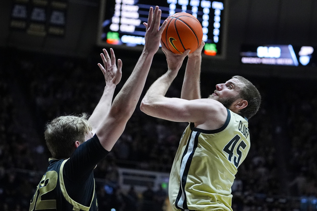 Purdue center Oscar Cluff (45) shoots over Oakland forward Isaac Garrett (32) during the second half of an NCAA college basketball game in West Lafayette, Ind., Friday, Nov. 7, 2025. (AP Photo/Michael Conroy)