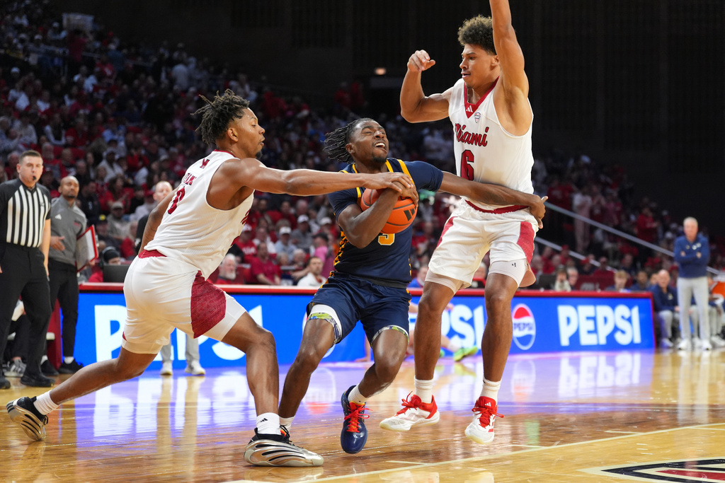 Toledo's Sonny Wilson, center, drives to the basket as Miami's (OH) Eian Elmer, and Justin Kirby, right, defend during the first half of an NCAA college basketball game, Tuesday, March 3, 2026, in Oxford, Ohio. (AP Photo/Kareem Elgazzar)