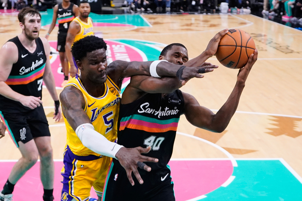 San Antonio Spurs forward Harrison Barnes (40) is fouled by Los Angeles Lakers center Deandre Ayton (5) during the second half of an NBA basketball game in San Antonio, Wednesday, Jan. 7, 2026. (AP Photo/Eric Gay)