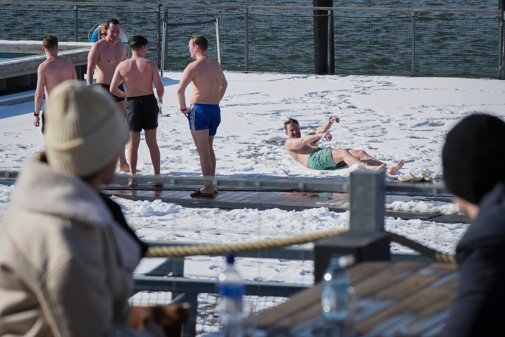 FILE - People spend time outside after using the sauna of the public bath in Helsinki, March 15, 2025. (AP Photo/Sergei Grits, File)