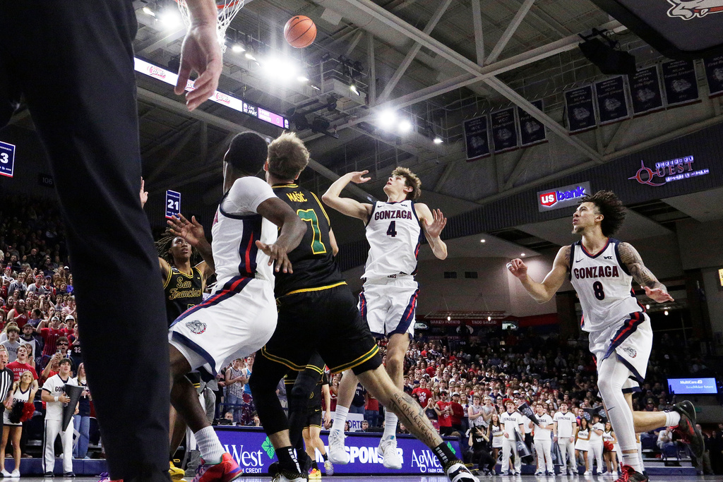 Gonzaga guard Davis Fogle (4) shoots during the first half of an NCAA college basketball game against San Francisco, Saturday, Jan. 24, 2026, in Spokane, Wash. (AP Photo/Young Kwak)
