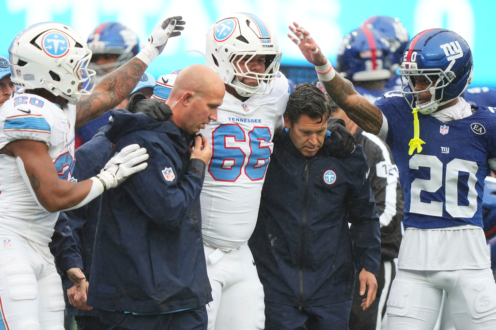 Tennessee Titans guard Fernando Carmona (66) is helped off the field after being injured during the first half of an NFL football game against the New York Giants in East Rutherford, N.J., Sunday, Sept. 27, 2026. (AP Photo/Frank Franklin II)
