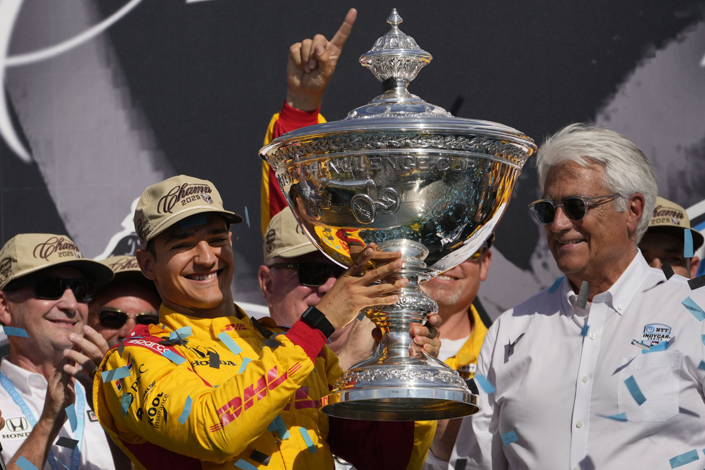 Alex Palou holds the trophy as he celebrates winning the IndyCar championship Sunday, Aug. 31, 2025, at Nashville Superspeedway in Lebanon, Tenn. (AP Photo/George Walker IV)