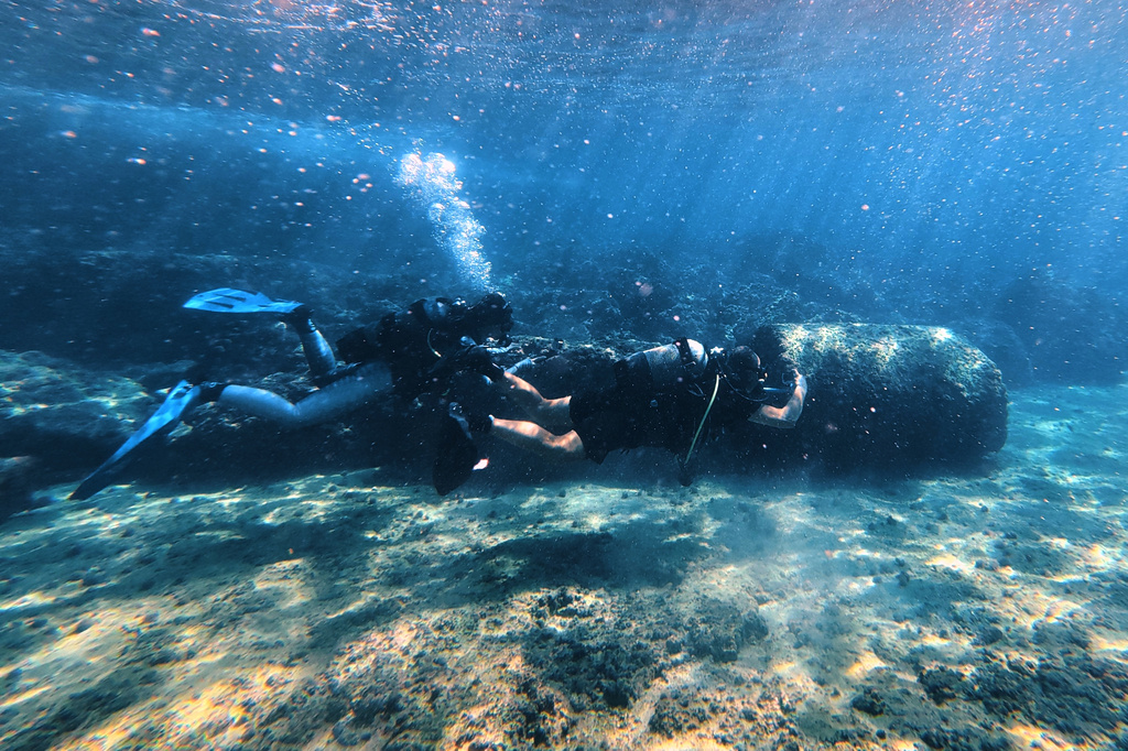 Manager of the Lebanon Diving Center Youssef Jundi, right, takes video of Roman-era columns at an archaeological site near the coast in the southern port city of Tyre, Lebanon, Thursday, Sept. 17, 2026. (AP Photo/Bilal Hussein)