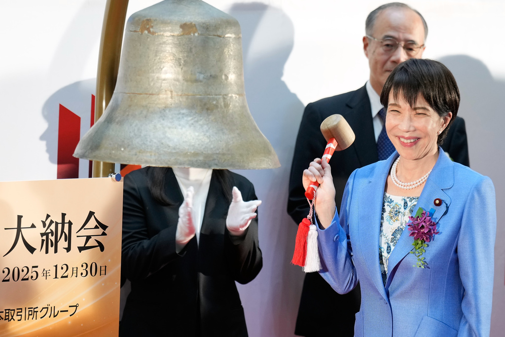 Japan's Prime Minister Sanae Takaichi poses before ringing the bell during a ceremony to mark the last trading day of the year on the Tokyo Stock Exchange Tuesday, Dec. 30, 2025, in Tokyo. (AP Photo/Eugene Hoshiko)