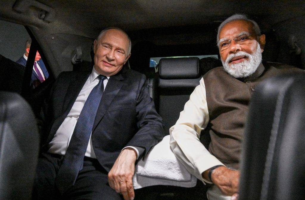 Russian President Vladimir Putin, and Indian Prime Minister Narendra Modi sit inside a limousine after arriving at the Palam Air Base in New Delhi, India, on Thursday, Dec. 4, 2025. (Grigory Sysoyev, Sputnik, Kremlin Pool Photo via AP)