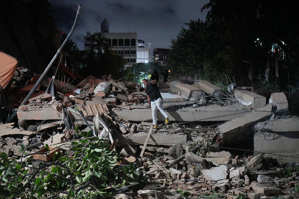 A man jumps on a collapsed building after an earthquake in Caracas, Venezuela, Wednesday, June 24, 2026. (AP Photo/Adrian Naranjo)