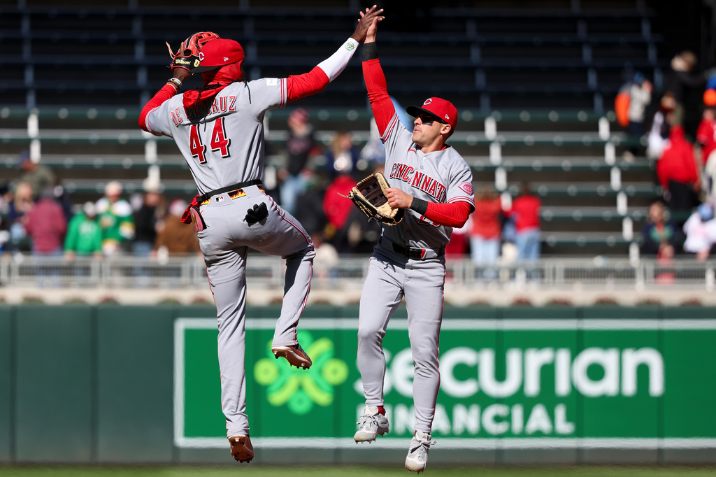 Cincinnati Reds shortstop Elly De La Cruz (44) and center fielder TJ Friedl (29) celebrate defeating the Minnesota Twins in a baseball game, Saturday, April 18, 2026, in Minneapolis. (AP Photo/Ellen Schmidt)