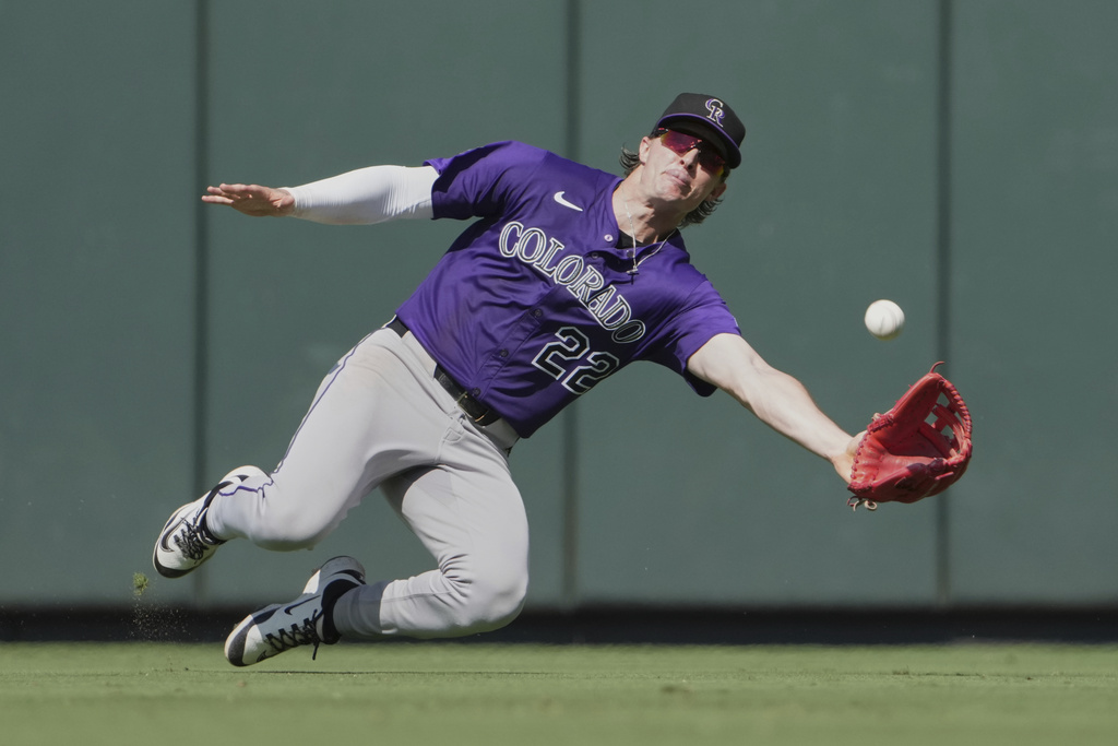Colorado Rockies center fielder Mickey Moniak catches a fly ball by St. Louis Cardinals' Pedro Pages during the ninth inning of a baseball game Wednesday, Aug. 13, 2025, in St. Louis. (AP Photo/Jeff Roberson)