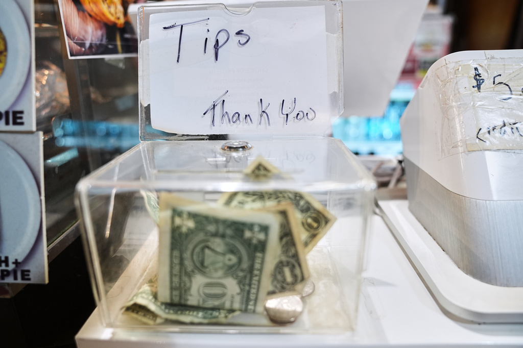 FILE - A tip box sits next to a register in Philadelphia on Dec. 10, 2025. (AP Photo/Matt Rourke, File)
