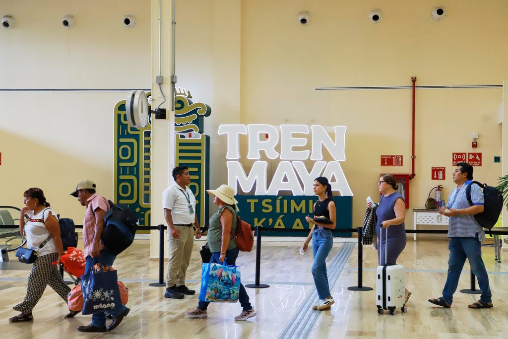 Passengers pass through a hallway to board the Maya Train in Mérida, Mexico, Thursday, Aug. 14, 2025. (AP Photo/Martin Zetina)