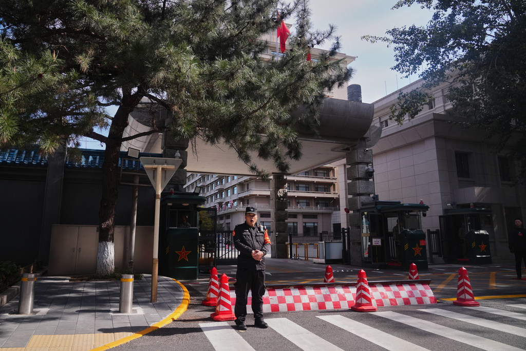 A Chinese security person yawns as he stands guard at the entrance gate to the Jingxi Hotel where the Communist Party's Central Committee is holding its fourth plenum, in Beijing, Monday, Oct. 20, 2025. (AP Photo/Andy Wong)